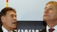 Michael Glos (l.) und Wolfgang Clement vor Schriftzug des Bundesministeriums für Wirtschaft und Technologie