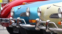 2 VW Karmann-Ghia Typ 14 und dahinter ein legendärer VW-Käfer auf der Retro Classics 2016, Europas größte Oldtimermesse.