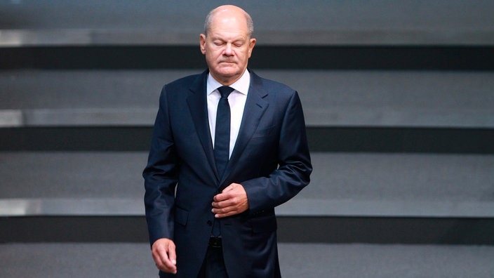 Bundeskanzler Olaf Scholz (SPD) mit geschlossenen Augen im Bundestag.