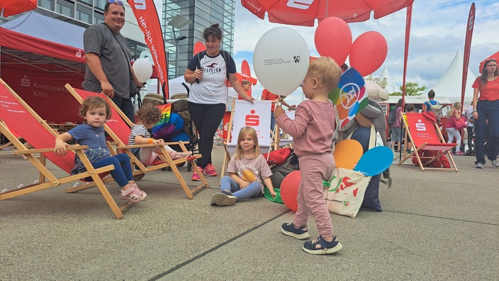 Kinder spielen am Sparkassenstand beim NRW-Tag in Köln