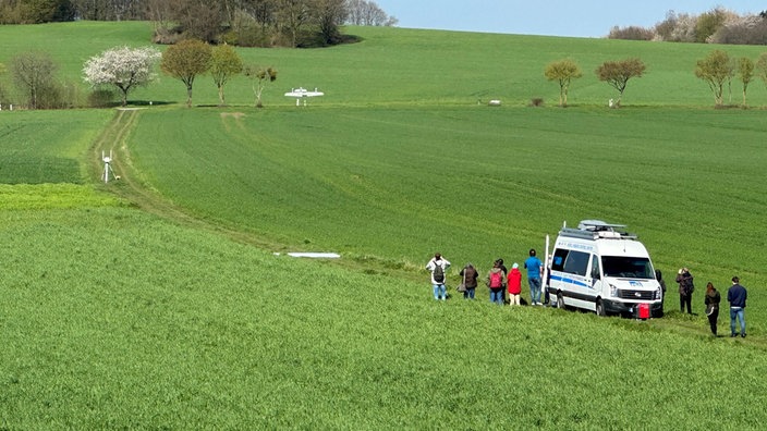 Drohne fliegt über ein grünes Feld