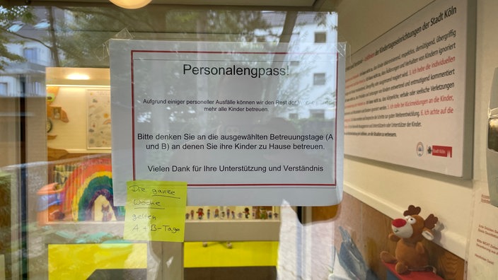 Informationsschild an Kölner KiTa. Wochentage werden aufgrund des Personalmangels in Betreuungstage A und B aufgeteilt.