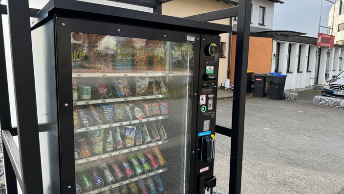 Ein Snackautomat steht an einem Bürgersteig