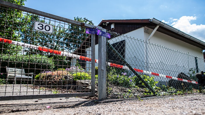 Die Gartenlaube, in der der Tatverdächtige die Straftaten begangen haben soll, davor Polizei-Absperrband.