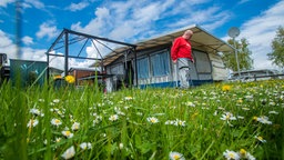 Camper vor seinem Wohnwagen mit Vorzelt