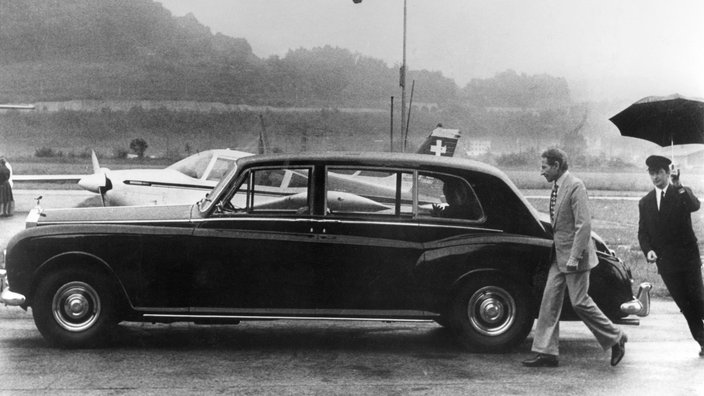 Helmut Horten und Chauffeur an Luxus-Limousine auf Flughafen Lugano