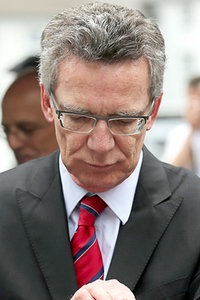 Thomas de Maizière blickt auf seine Uhr