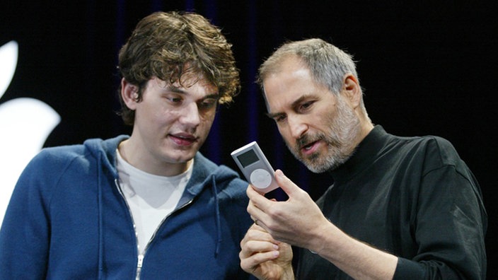 Steve Jobs betrachtet mit einem Fan einen iPod