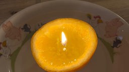 Orange mit Kerzendocht