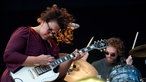 Frontfrau der Alabama Shakes spielt Gitarre und schüttelt ihr Haar, im Hintergrund spielt der Schlagzeuger