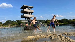 Zwei Jungs spielen am Wasser