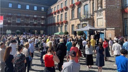 Rund 500 Menschen beten gemeinsam vor dem Düsseldorfer Rathaus