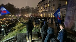 Kleine Gruppe von AFD-Anhängern schwenkt Fahnen