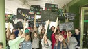 Schulkinder strecken Plakate gegen Rassismus in die Höhe 