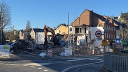 Bagger vor einem Haus, das abgerissen wird