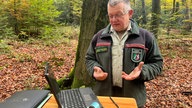 Lutz Jaschke, Sachgebietsleiter Großrauminventuren, Wald und Holz NRW, mitr einem Laptop im Wald