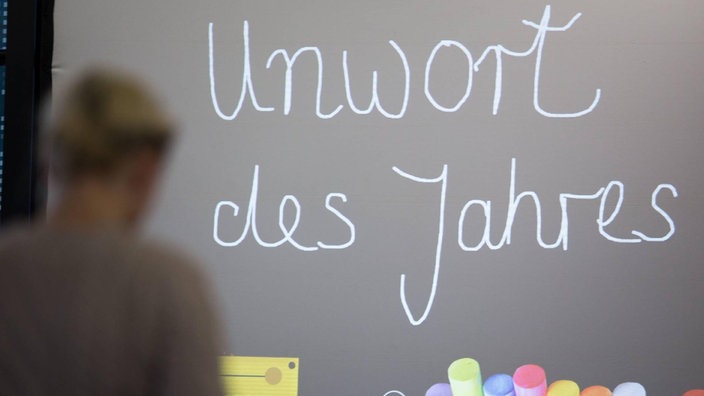 Auf einer Tafel steht: "Unwort des Jahres"