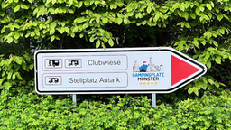 Ein Schild, das zum Campingplatz führt 