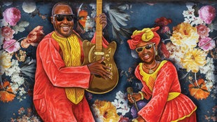 Cover des Albums "La vie est belle" von Amadou & Mariam: Bunte Zeichnung von Amadou und Mariam in gelb-roter Kleidung mit Gitarre und Mikrophon