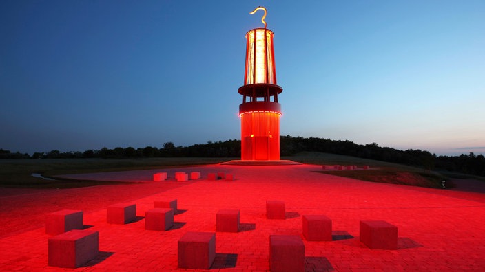 Blick auf "Das Geleucht" am Abend mit rot beleuchteter Halde