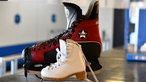 Eissporthalle Grefrath: Ein kleiner und ein sehr großer Schlittschuh stehen nebeneinander