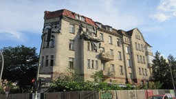 Leerstehendes Wohnhaus in Berlin. Die Fassade ist zum Teil beschädigt.