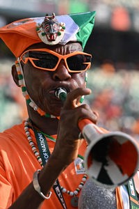 An Ivory Coast supporter blows a vuvuzela