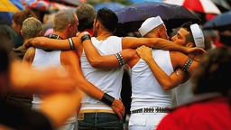 Symbolbild für Abschaffung Paragraph 175: Als Matrosen verkleidete Männer umarmen sich