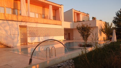 Die Pool-Anlage des Hotel Gracanica in das orangene Licht der Morgensonne getaucht.