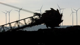  Ein Braunkohlebagger vom RWE arbeitet bei Jüchen, im Hintergrund Windräder. 