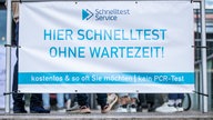 Auf dem Bild sieht man ein Plakat mit der Aufschrift: "Hier Schnelltest ohne Wartezeit".